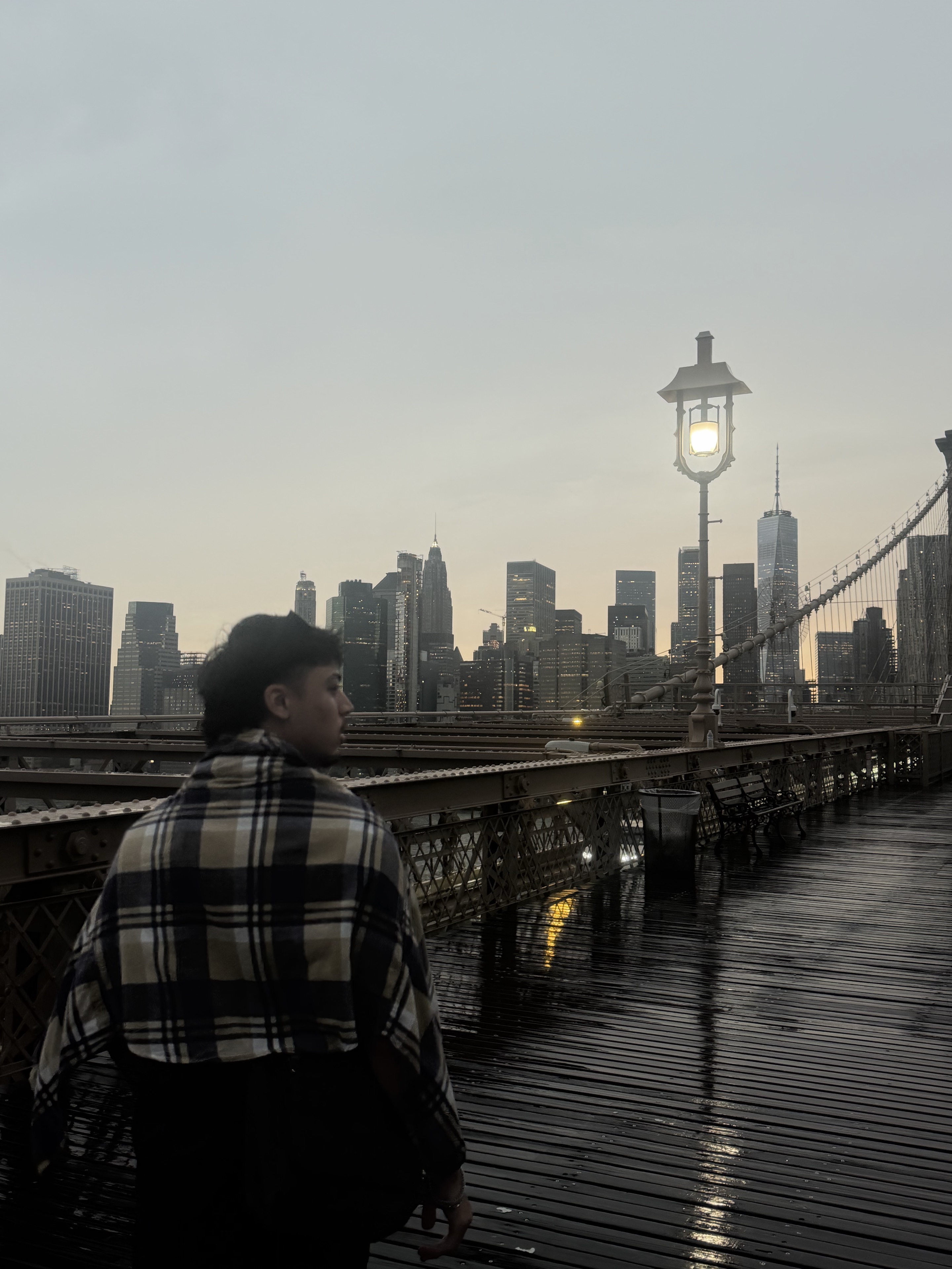 Swopnab on the Brooklyn Bridge with the skyline behind him